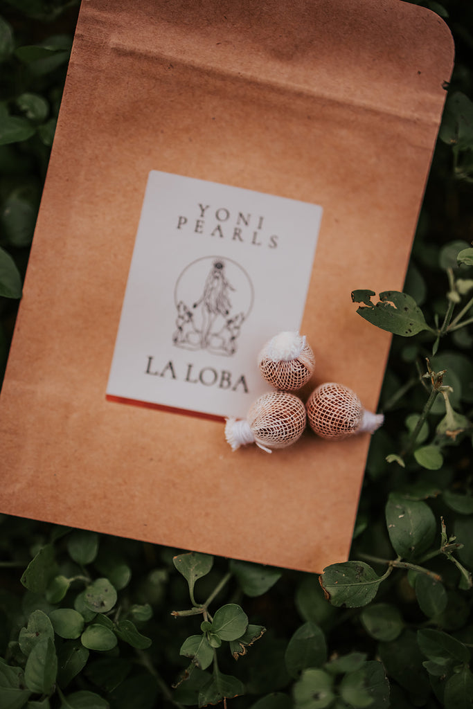 Yoni Pearls packaging with 'La Loba' branding on a natural background